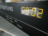 Schwarzer Leuchtkasten mit weier LED leuchtender Schrift, eingebauter Uhr und schwarz lackierten Aluminium Rahmen fr den Flughafen in Mnchen